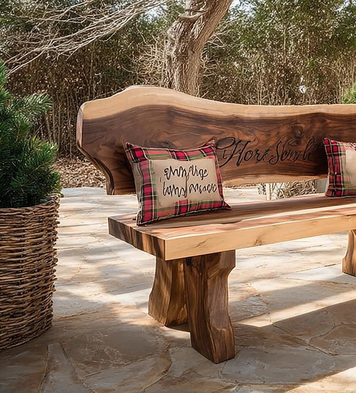 Rustic wooden bench with natural wood grain and decorative plaid pillows on stone patio