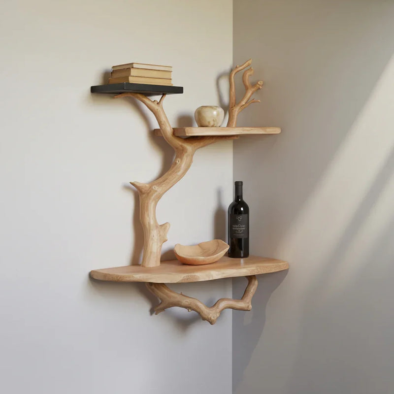 Live edge floating tree bookshelf with books and decor on solid wood shelves in a corner.