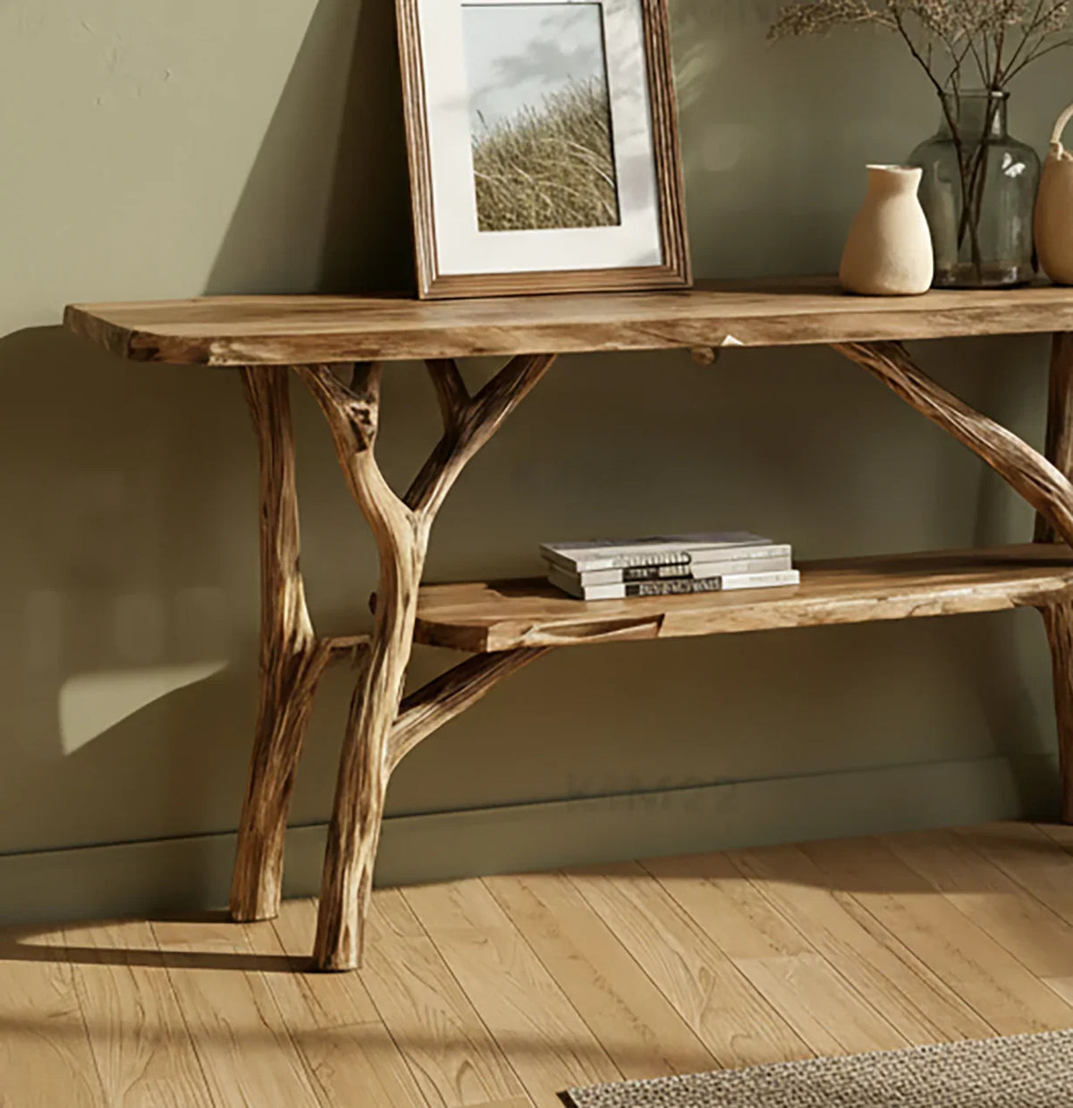 Rustic wooden console table with natural branch legs, framed nature photo, books, and ceramic vases