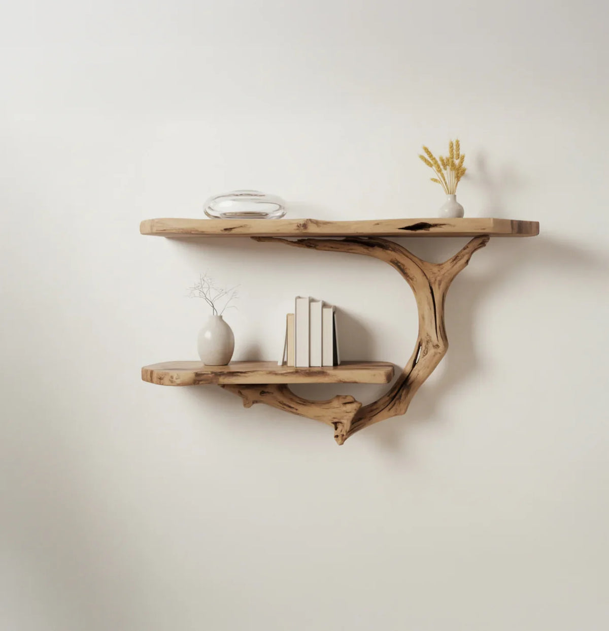 Minimalist wooden wall shelves with natural branch support holding vases and stacked books