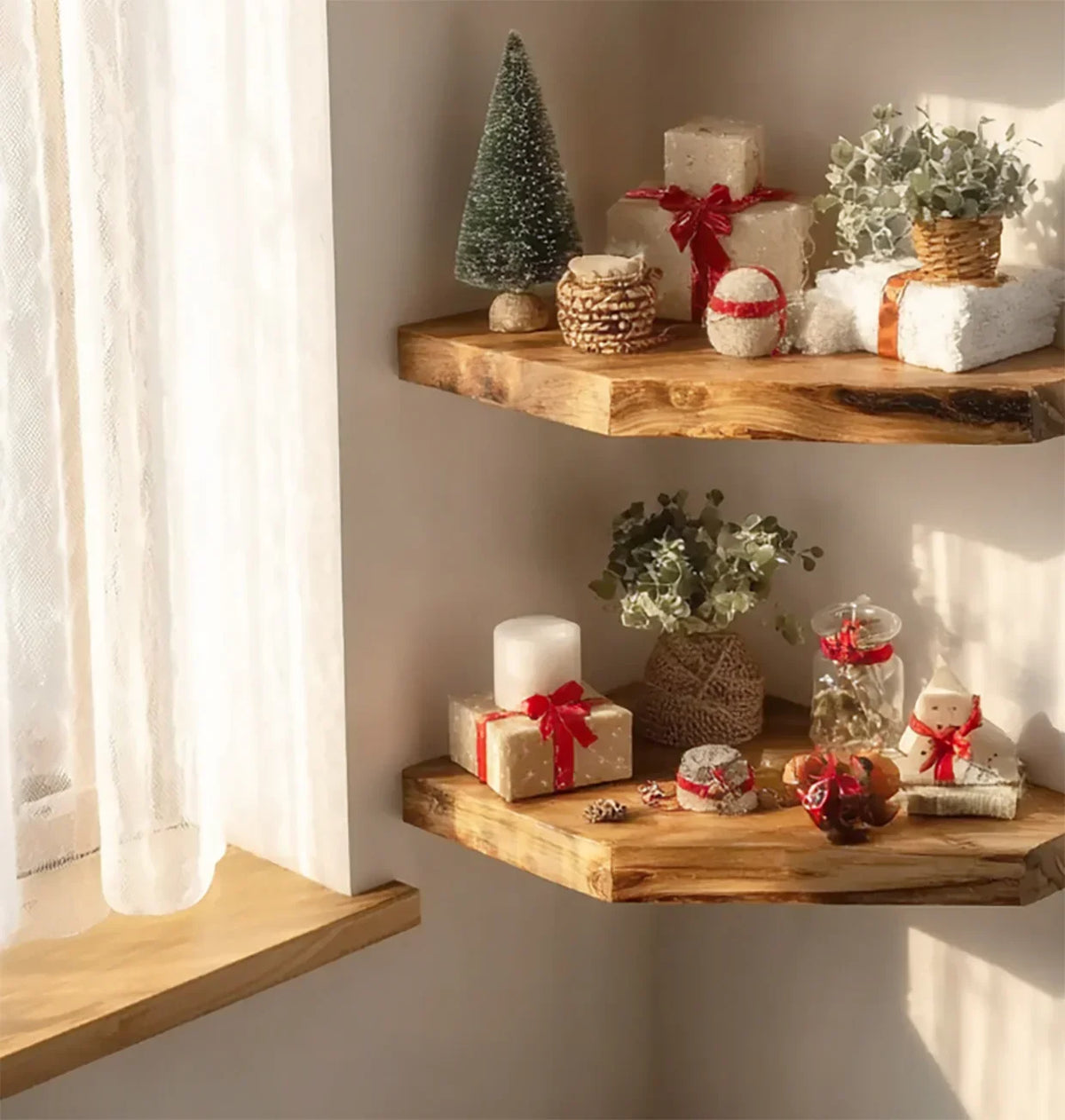 Sunlit wooden corner shelves with Christmas gifts, a small tree, wicker baskets, candles, and green plants