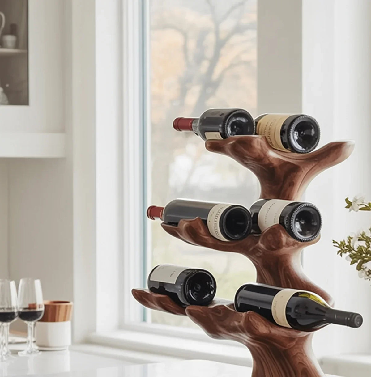 Solid wood tree bookshelf wine rack holding bottles in a modern kitchen setting