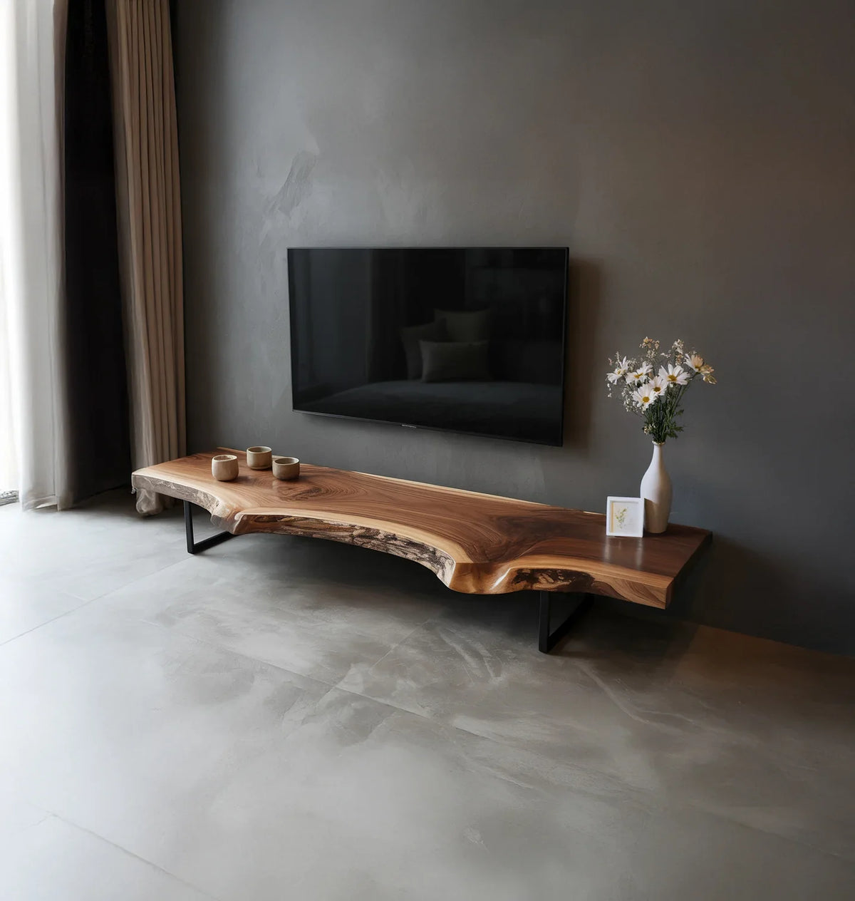 Minimalist living room with wall-mounted TV and live edge wood TV stand decorated with vase and cups