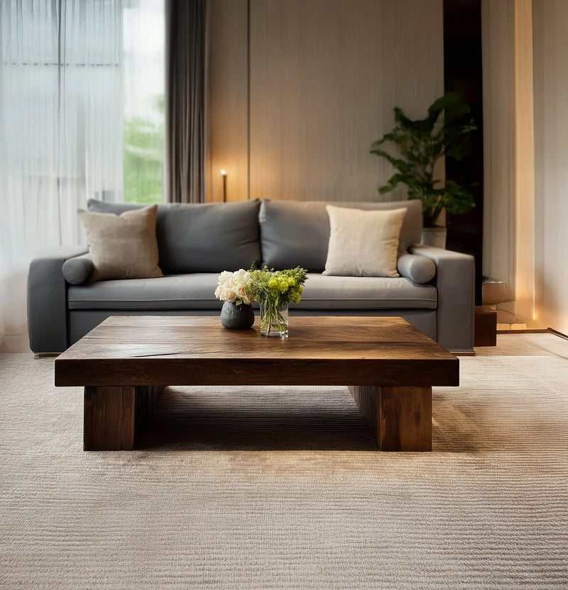 Solid wood live edge coffee table in modern living room with grey sofa and flowers