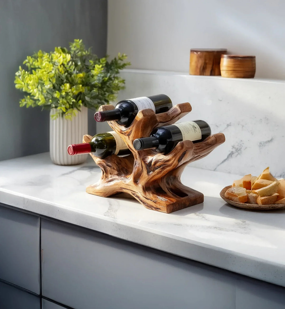 Live edge solid wood wine rack holding three bottles on a marble kitchen countertop