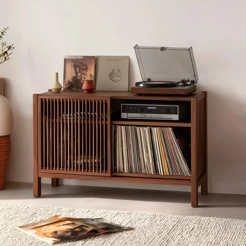 Solid wood media console with slatted doors, record player, and vinyl storage in a modern room