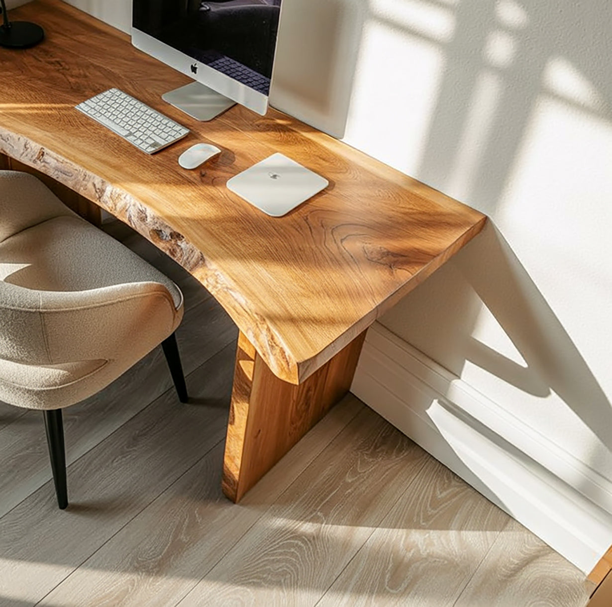 Solid wood live edge desk with modern computer setup in a sunlit room