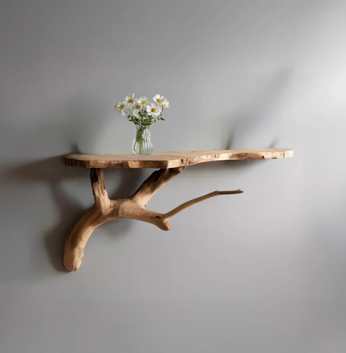 Live edge solid wood floating shelf with natural branch support, vase with daisies on top