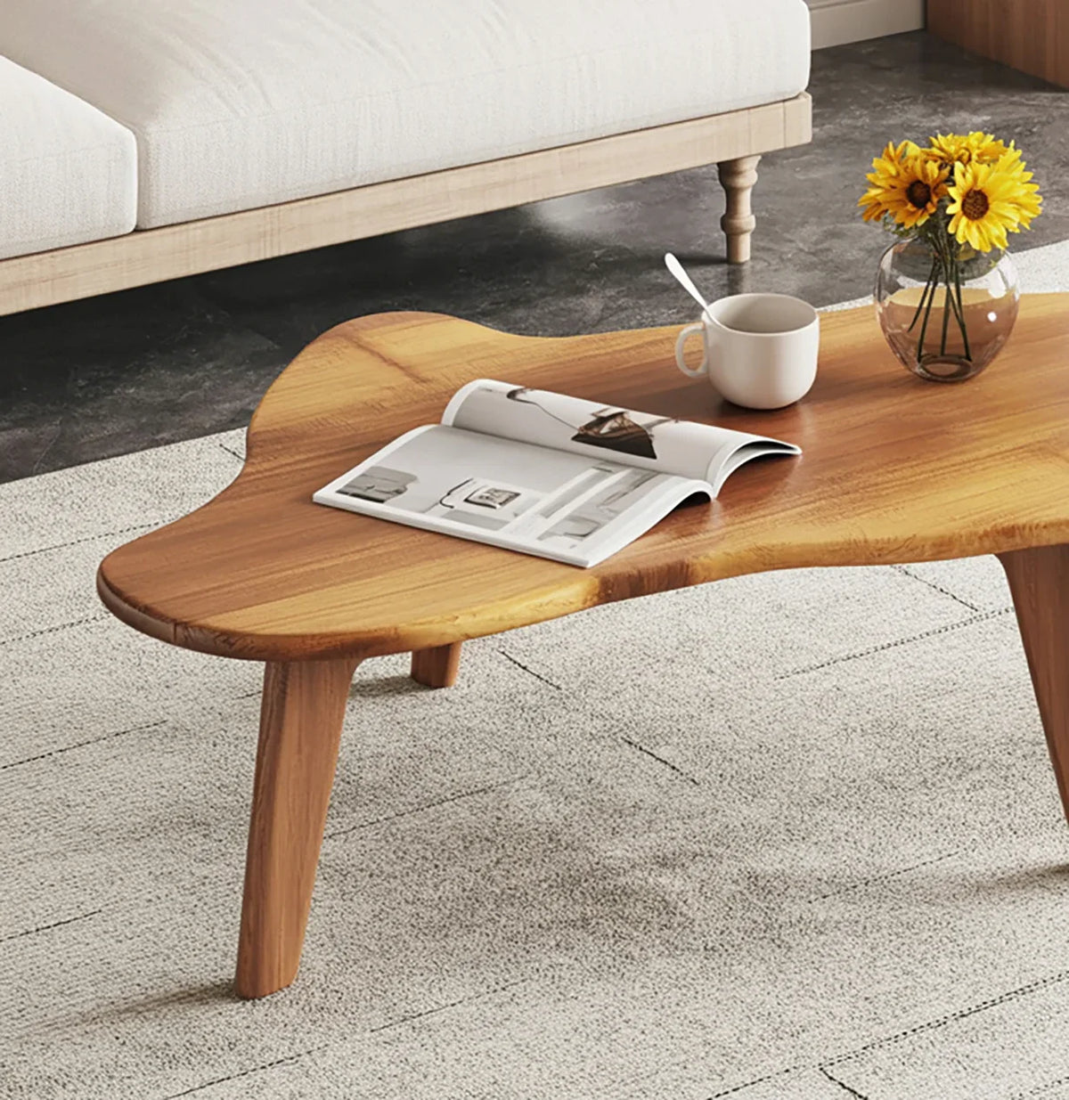 Live edge solid wood coffee table with vase, cup, and magazine in modern living room