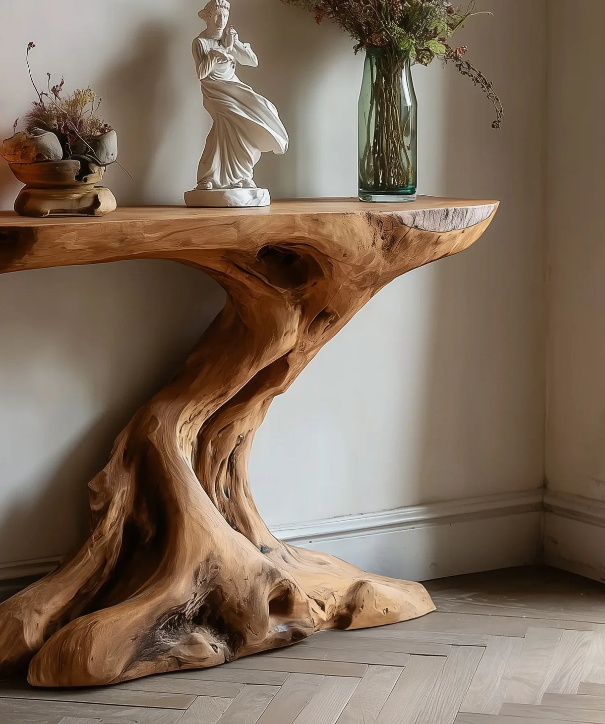 Live edge solid wood console table with sculpted organic base, decor and vase on top