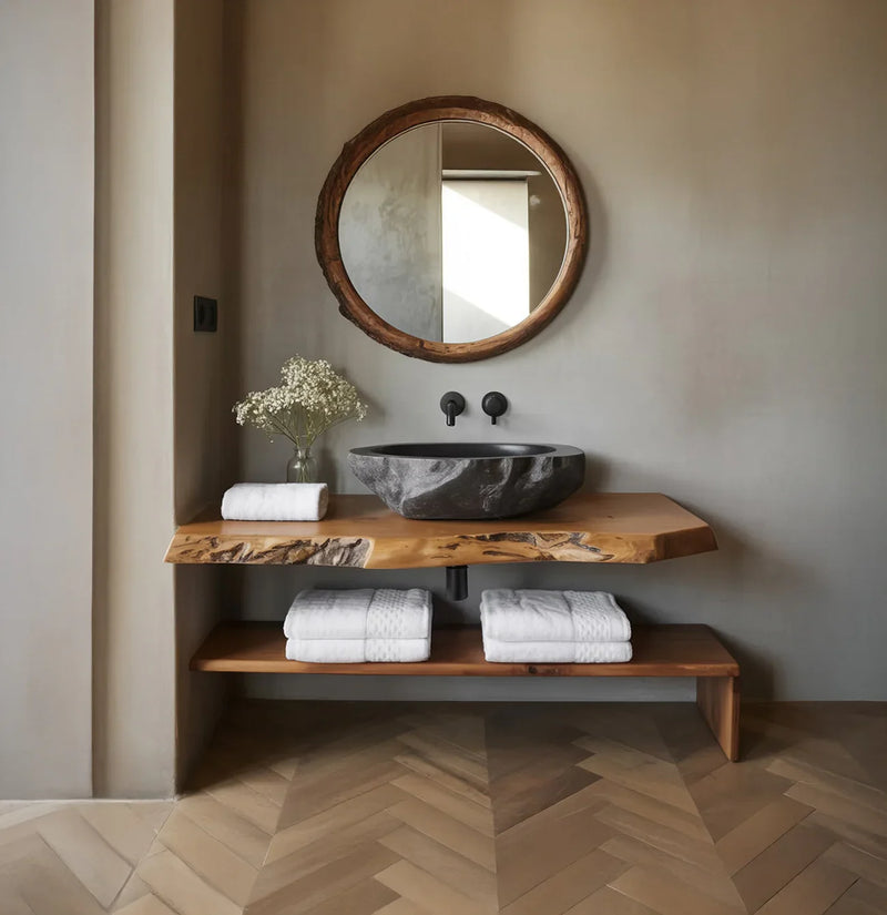 Live edge wood vanity with stone basin, round mirror, and modern bathroom decor