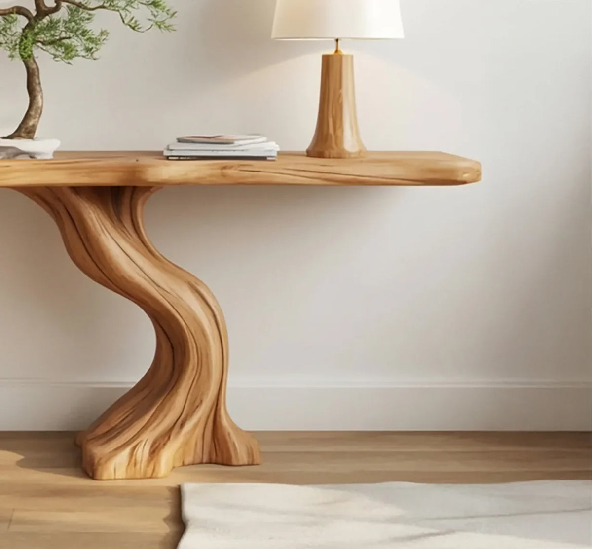 Solid wood live edge console table with curved base, bonsai plant, and lamp in a modern room