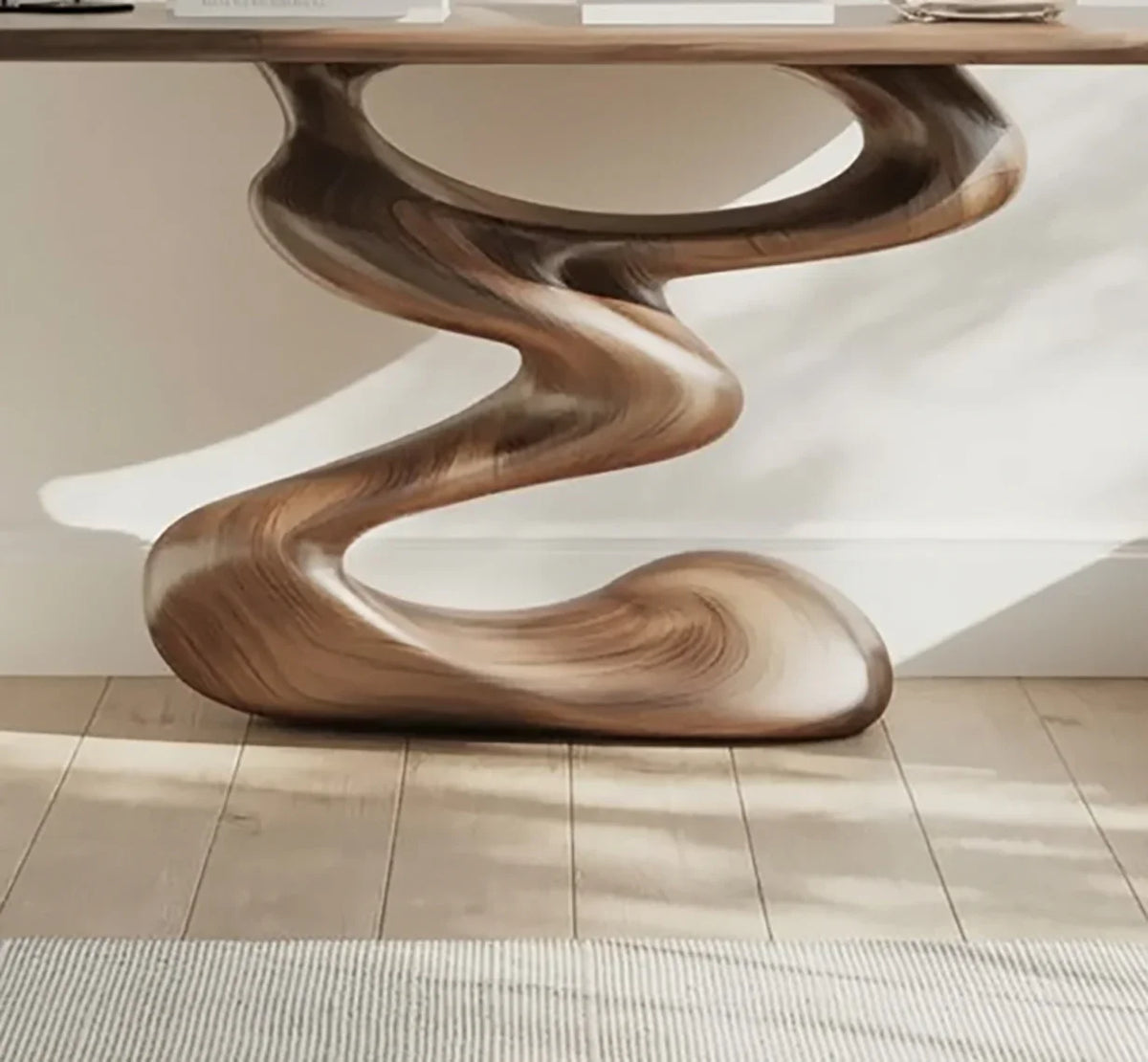 Modern sculptural solid wood table with unique flowing base on wooden floor