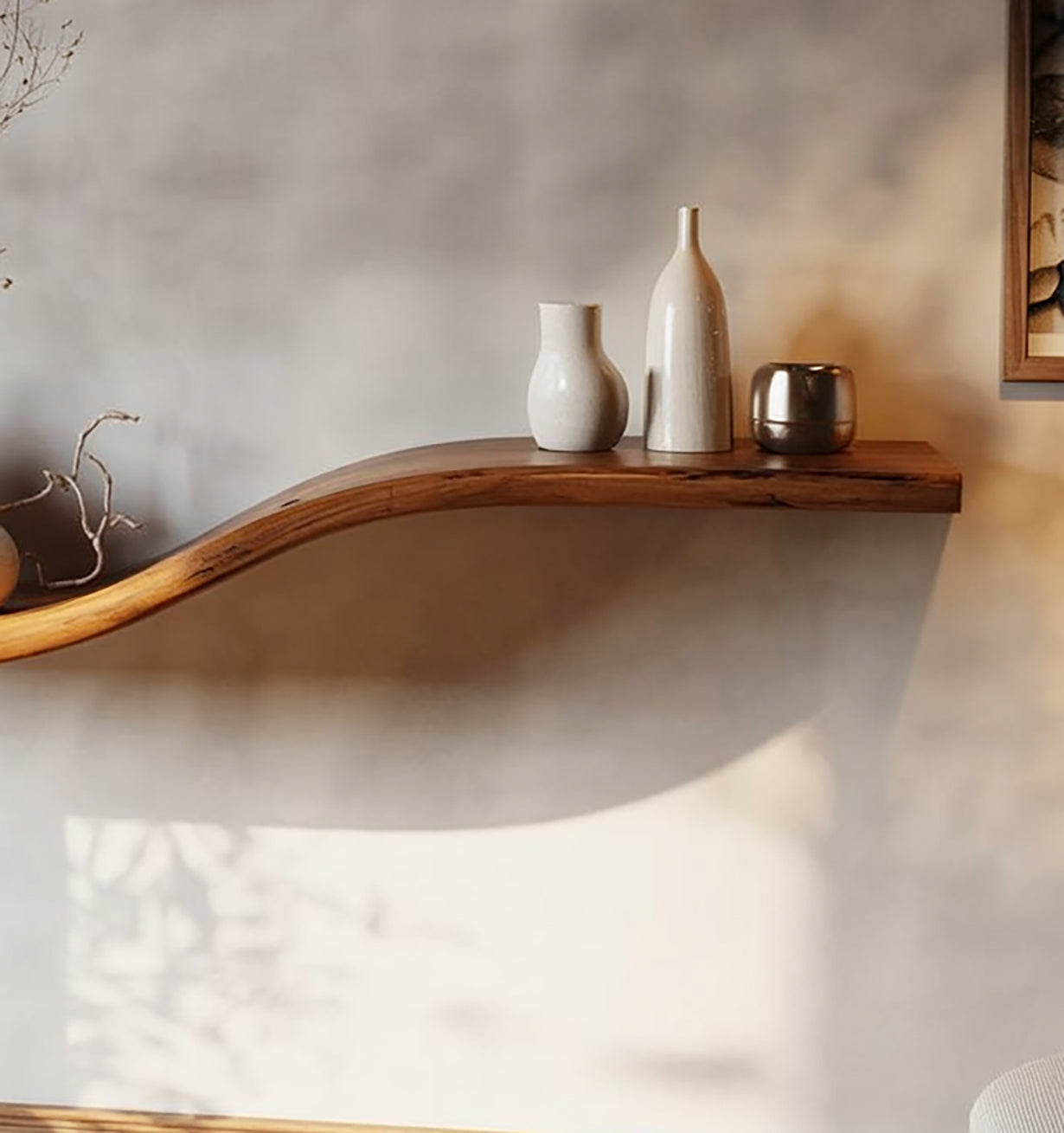 Curved live edge wooden floating shelf with ceramic vases and modern decor against a light wall.