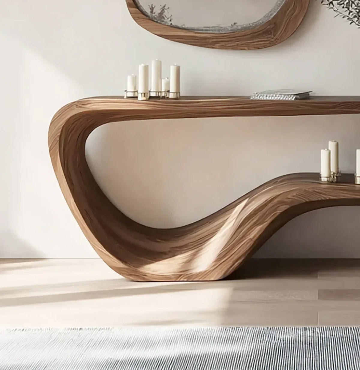 Modern live edge solid wood console table with smooth curves, candles, and decorative mirror