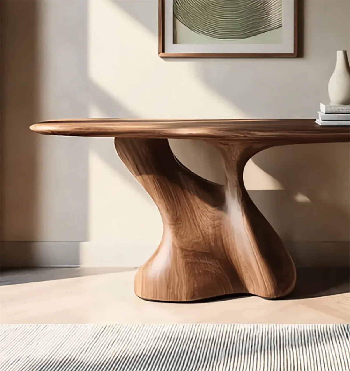 Smooth modern wooden dining table with sculptural base in sunlit minimalist room