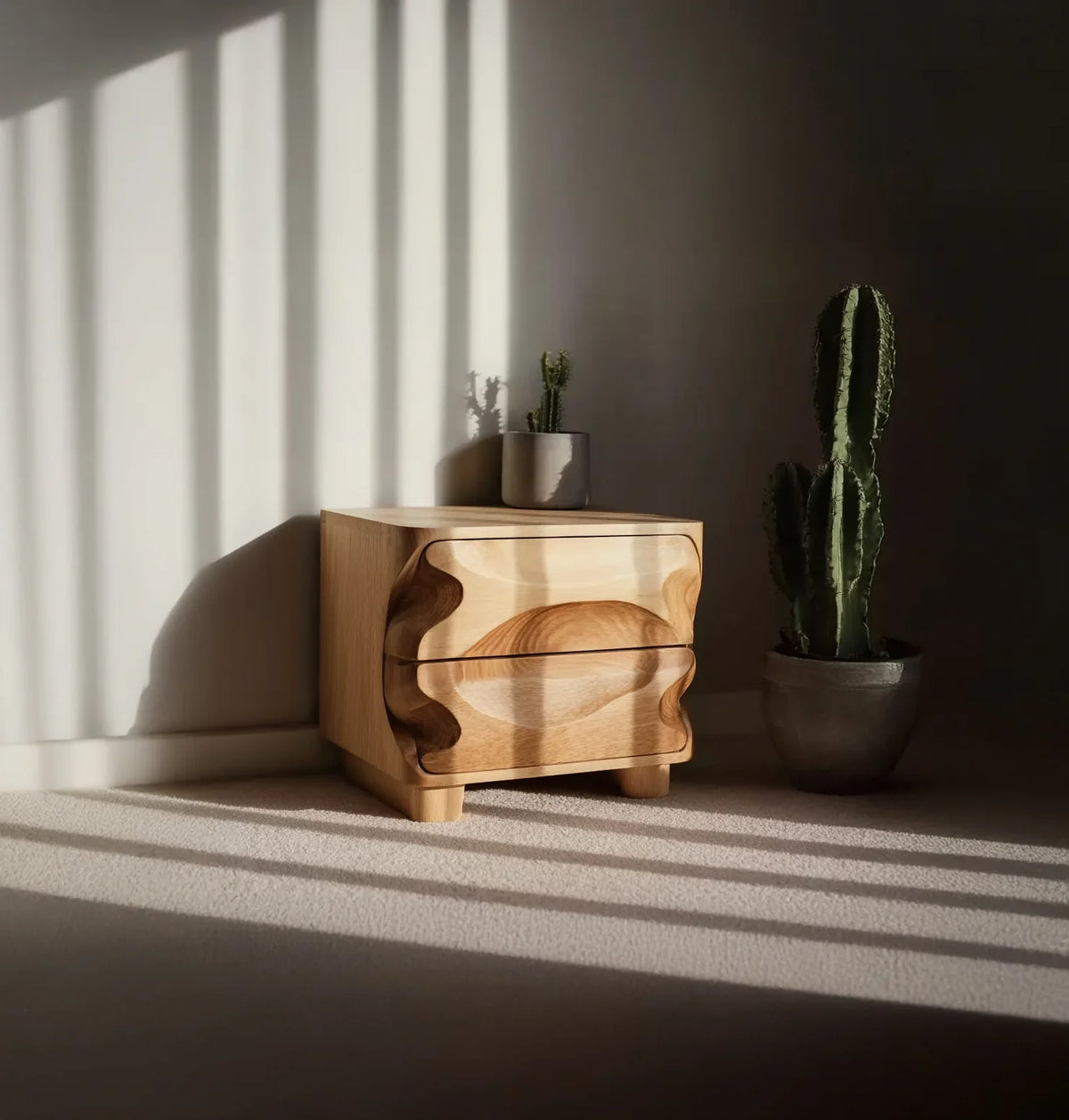 Modern wooden nightstand with wavy drawer design beside potted cactus in sunlit room