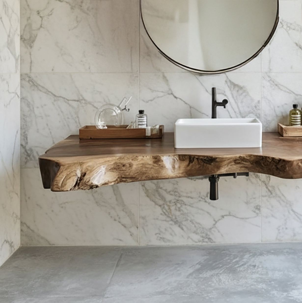 Modern bathroom with live edge wood countertop, white rectangular sink, black faucet, and round mirror on marble wall