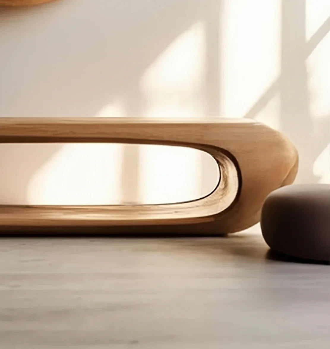 Minimalist solid wood bench with organic cutout design in natural light