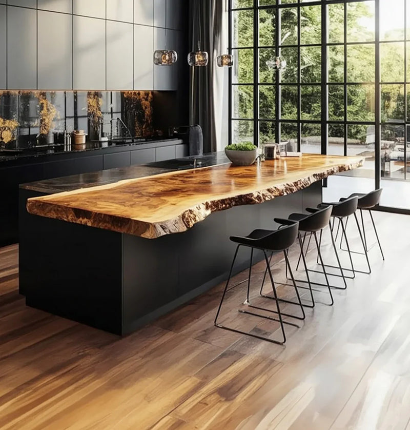 Modern kitchen with large live edge solid wood island, black stools, and floor-to-ceiling windows.