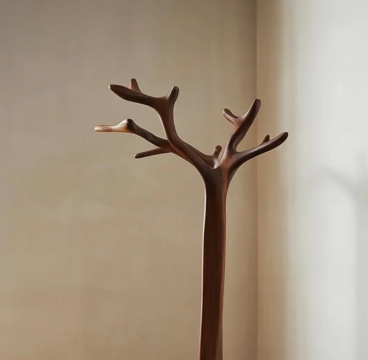 Solid wood tree bookshelf with natural branch design against beige wall