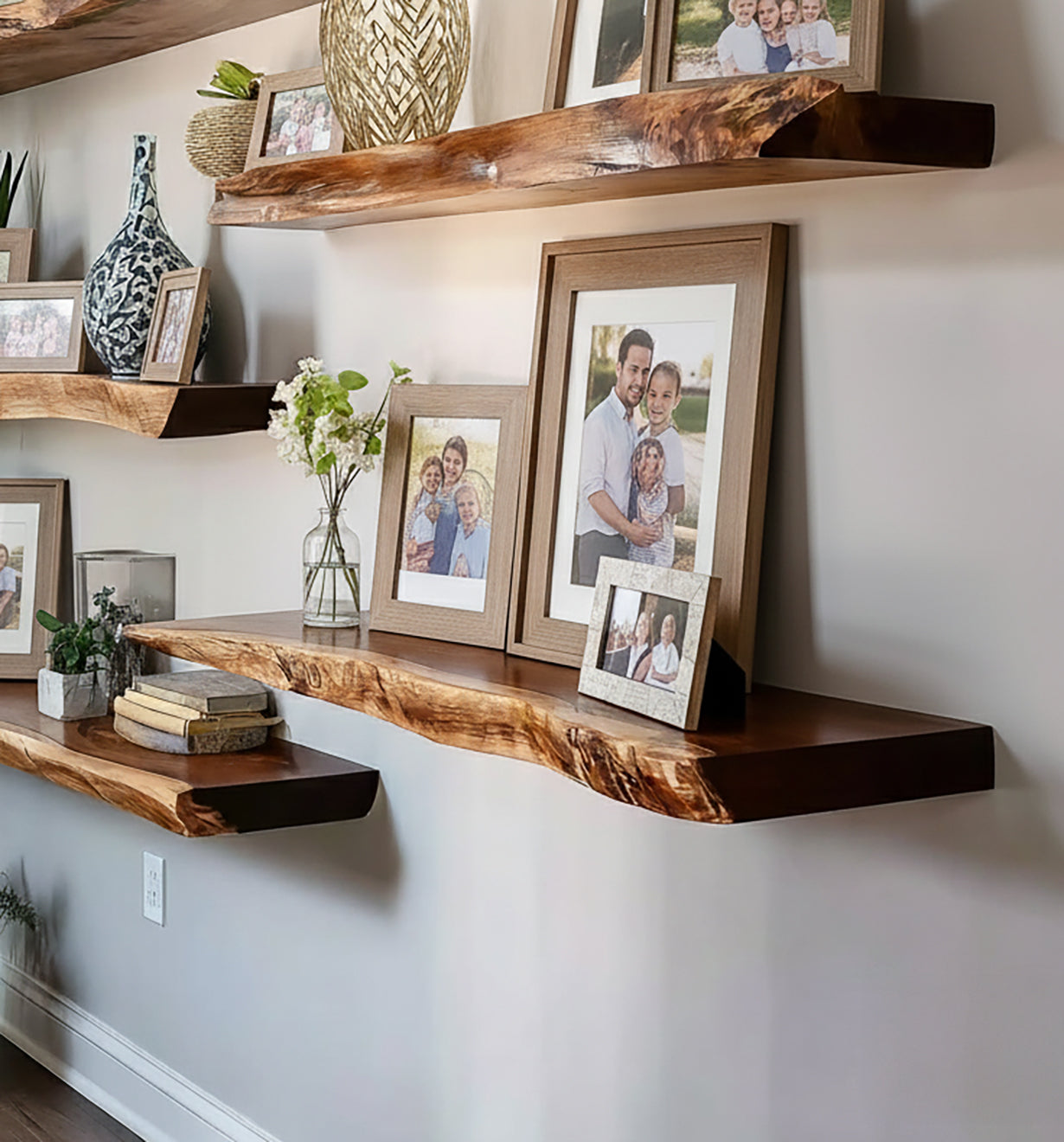 Live edge wooden floating shelves on wall decorated with family photos, books, plants, and decorative vases