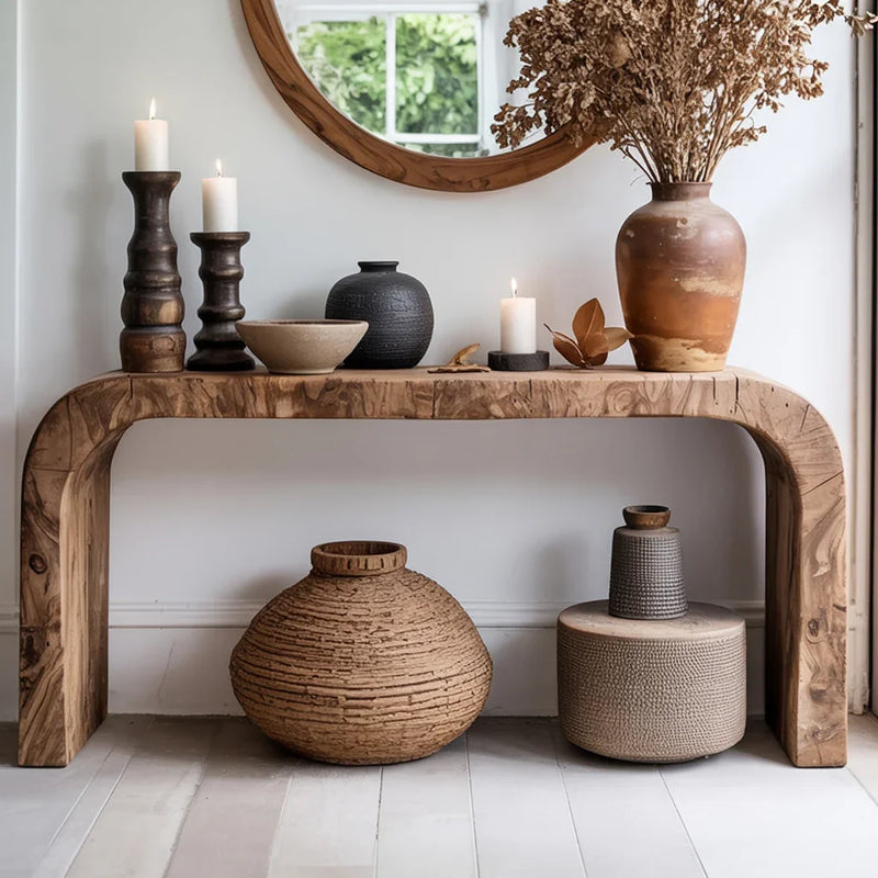 Live edge solid wood console table with candles, ceramic vases, and rustic decor in modern entryway
