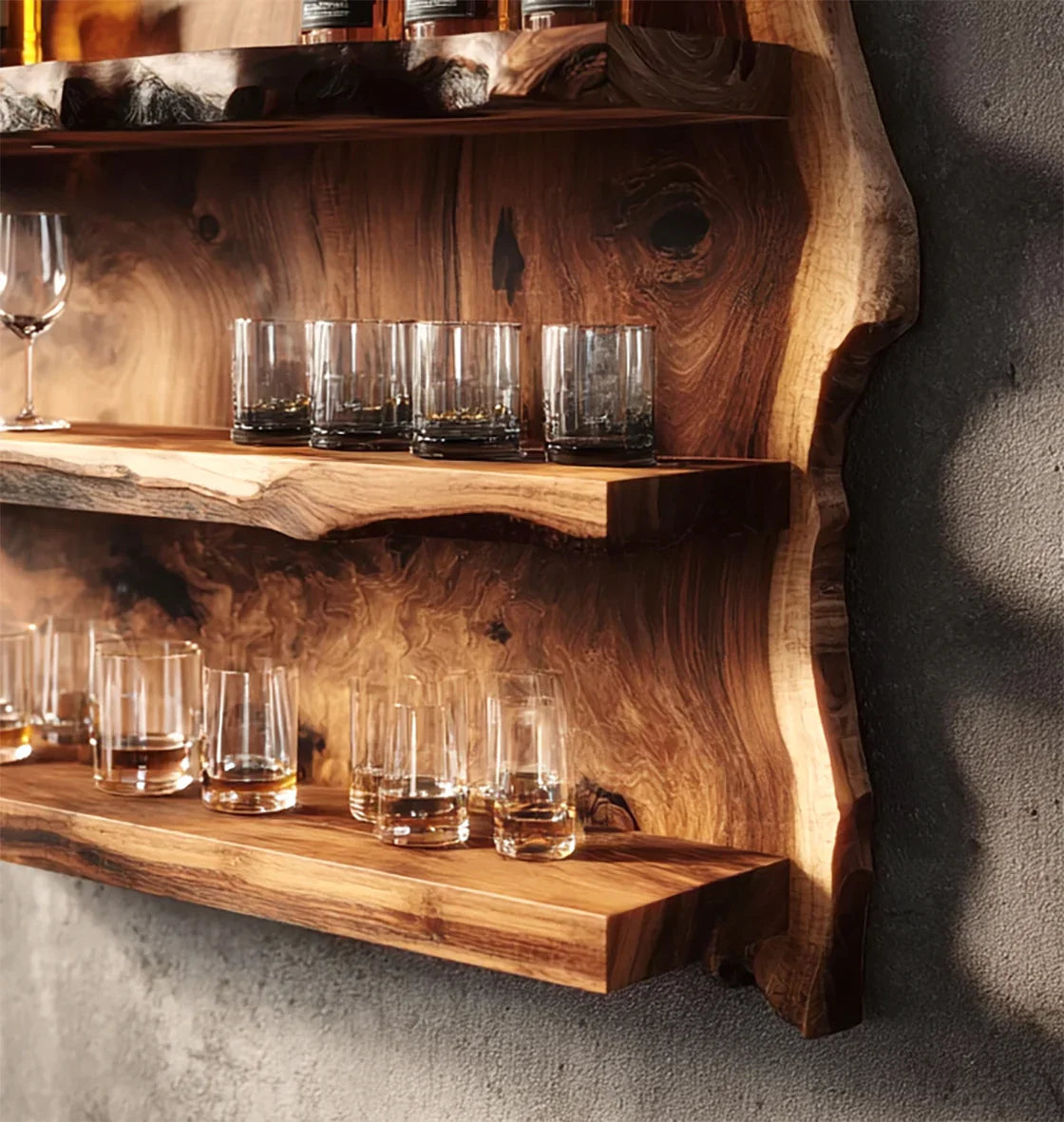 Rustic wooden wall shelves with whiskey glasses and a wine glass against textured gray wall