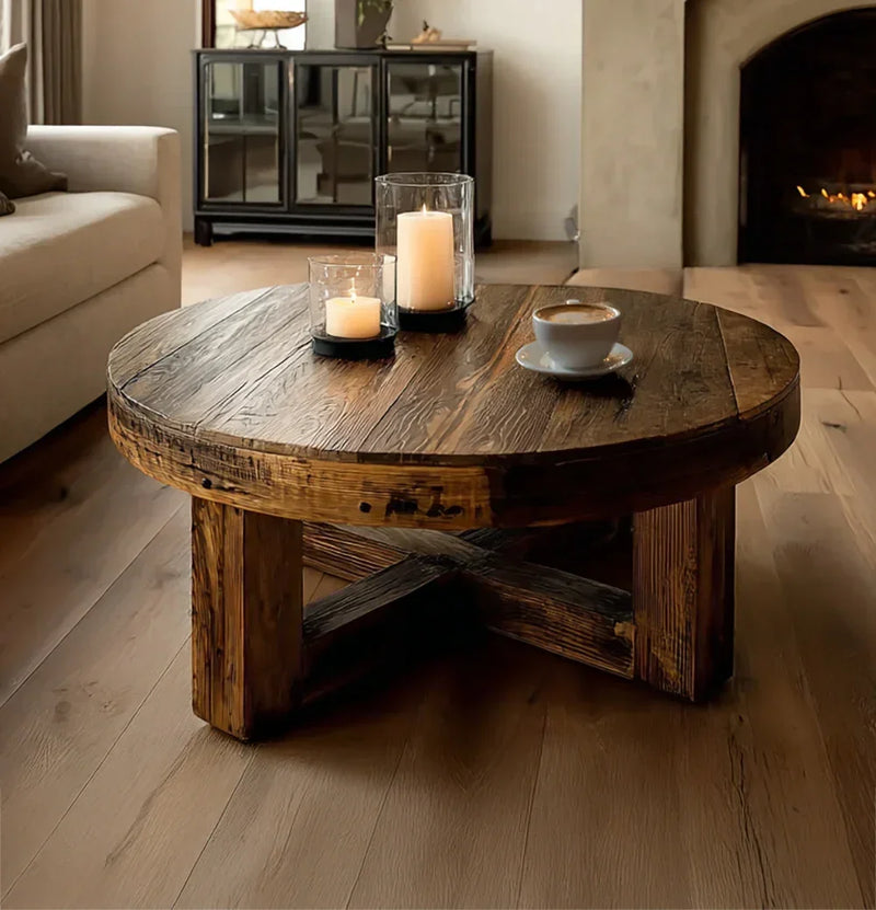 Rustic solid wood round coffee table in living room with candles and coffee cup