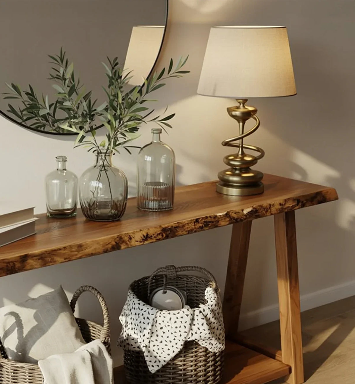 Rustic wooden console table with decorative glass bottles, leafy branch, brass lamp, and wicker baskets