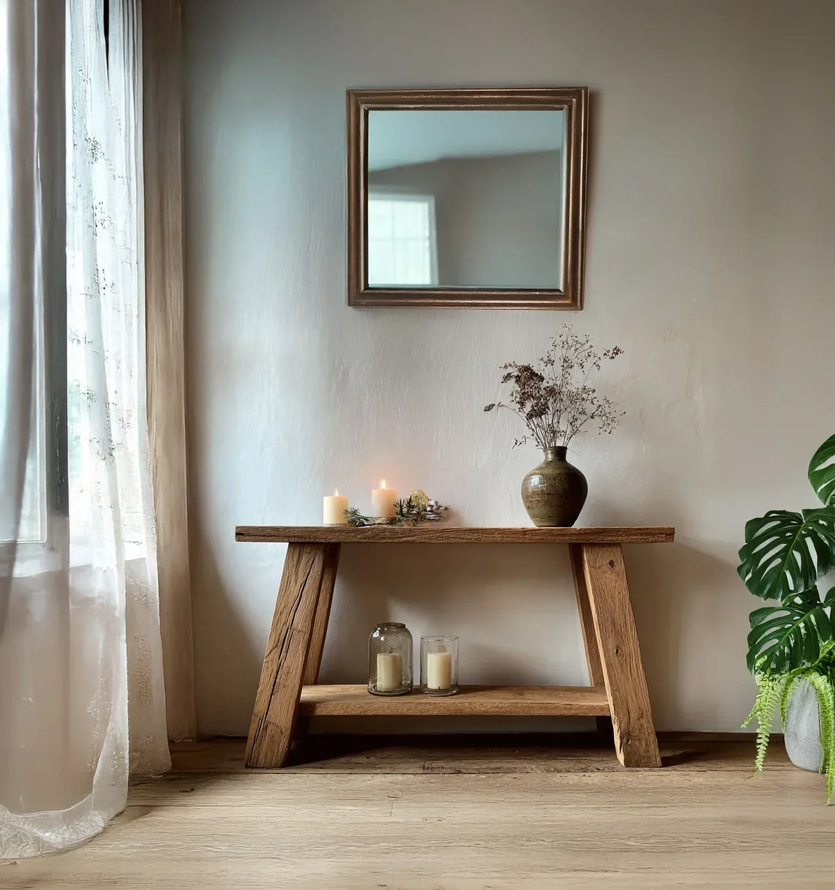 Solid wood console table with dried flowers, candles, and modern decor in a cozy living space