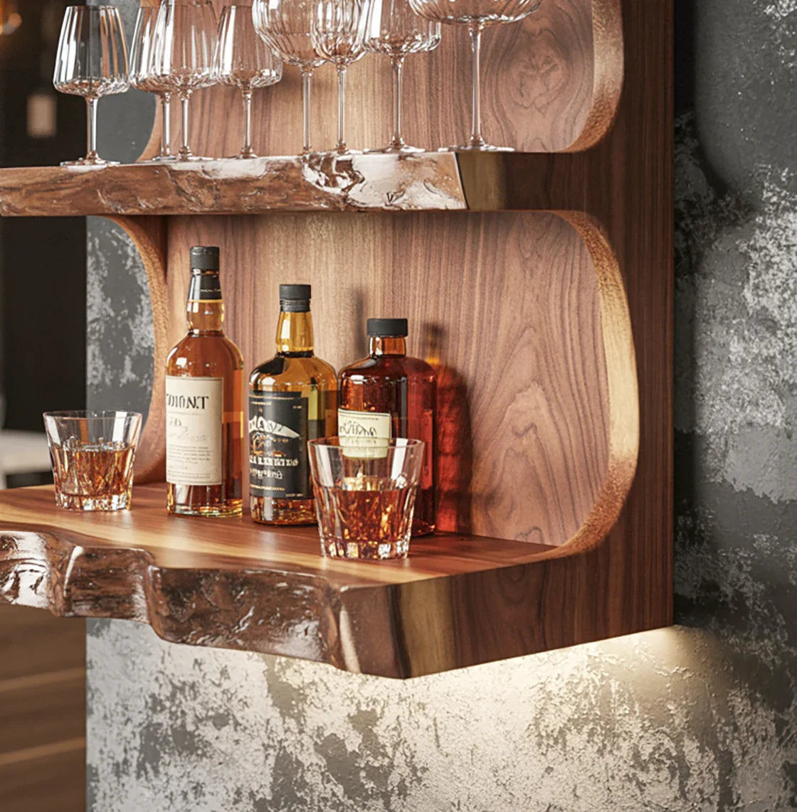 Wall-mounted live edge wooden bar shelf with whiskey bottles, glasses, and hanging wine glasses