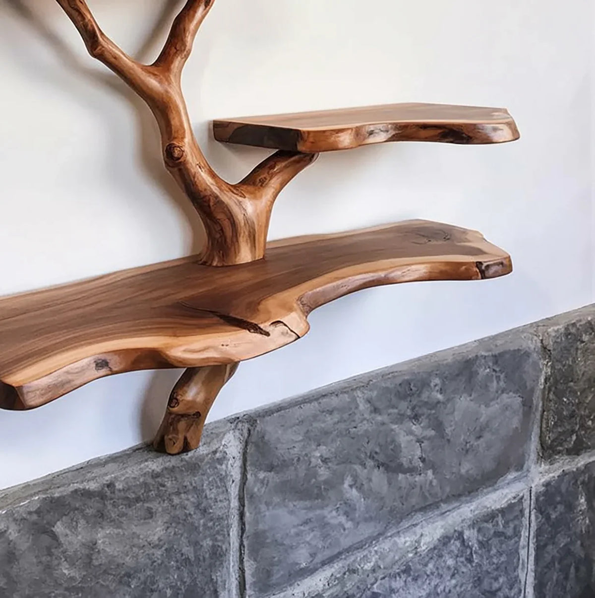 Live edge solid wood tree bookshelf with natural finish mounted on wall above stone surface