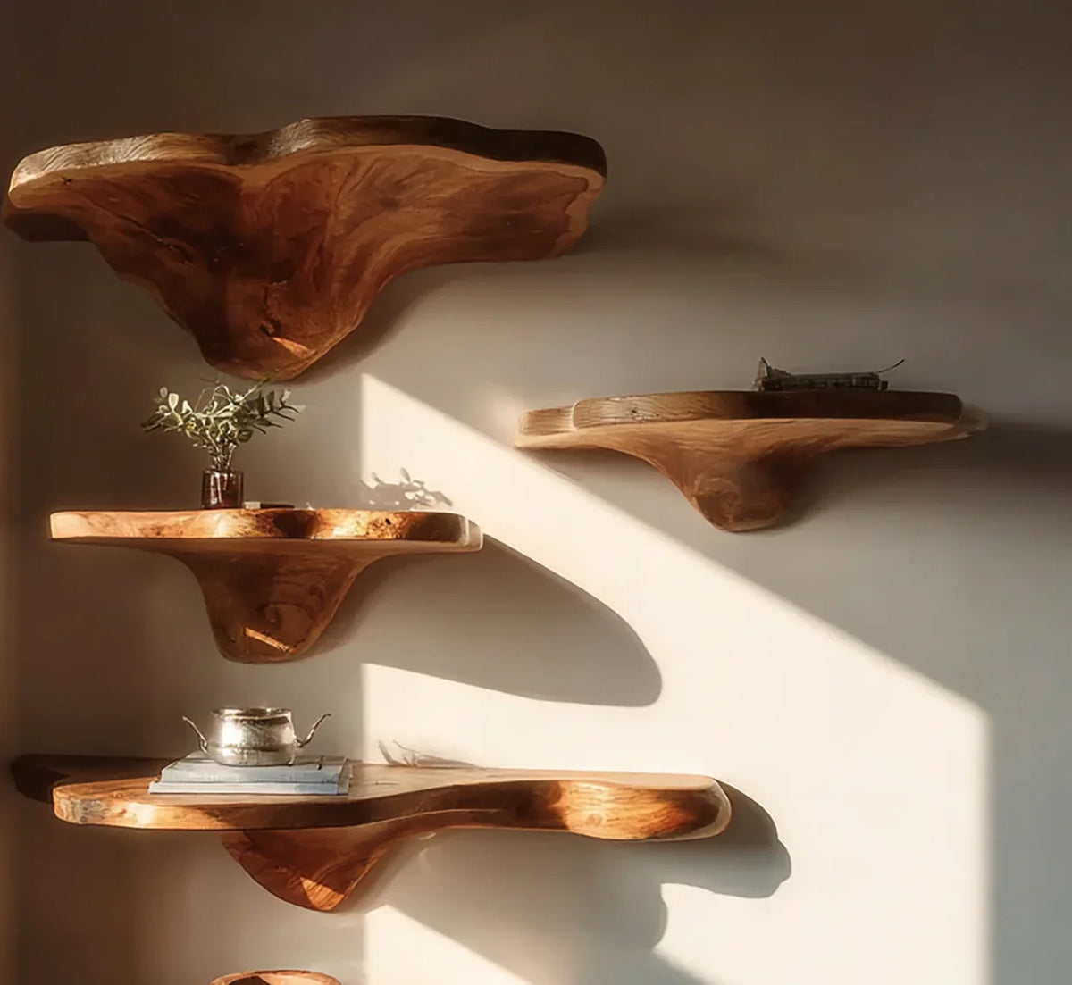 Live edge solid wood floating shelves mounted on a wall, natural light, minimalist decor.