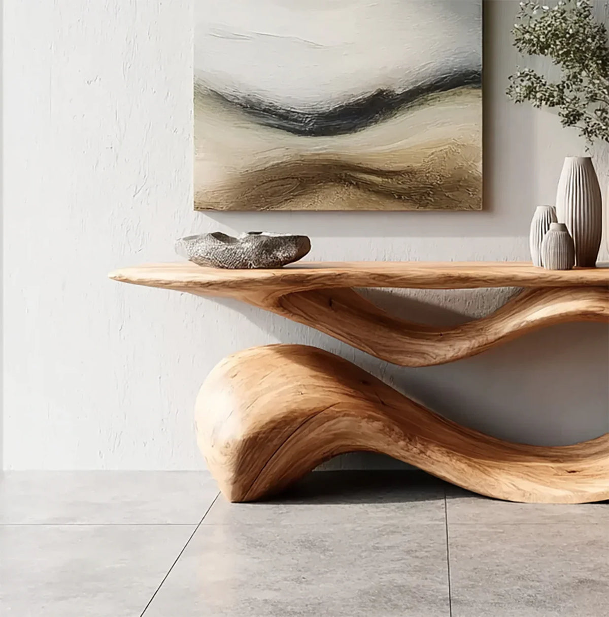 Modern natural wood sculptural console table under abstract landscape painting with decorative vases