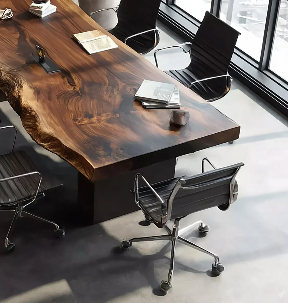 Live edge solid wood conference table with modern chairs in a bright office space