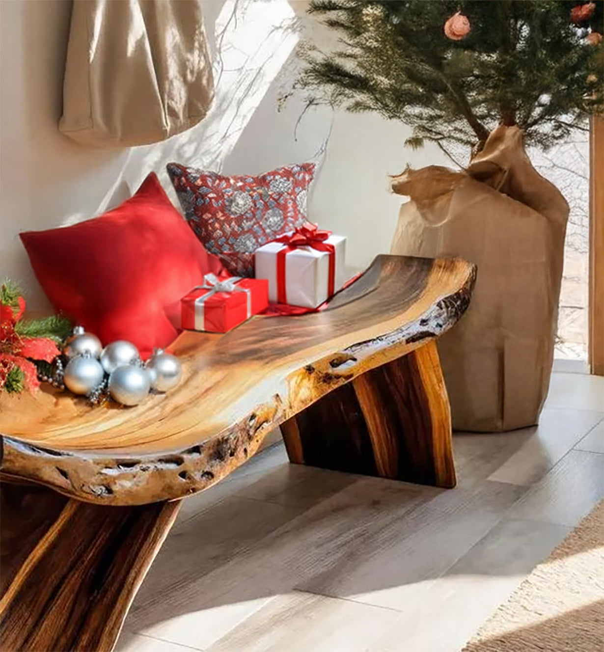 Rustic wooden bench with red and patterned pillows, Christmas gifts, ornaments, and a decorated tree in a sunny room