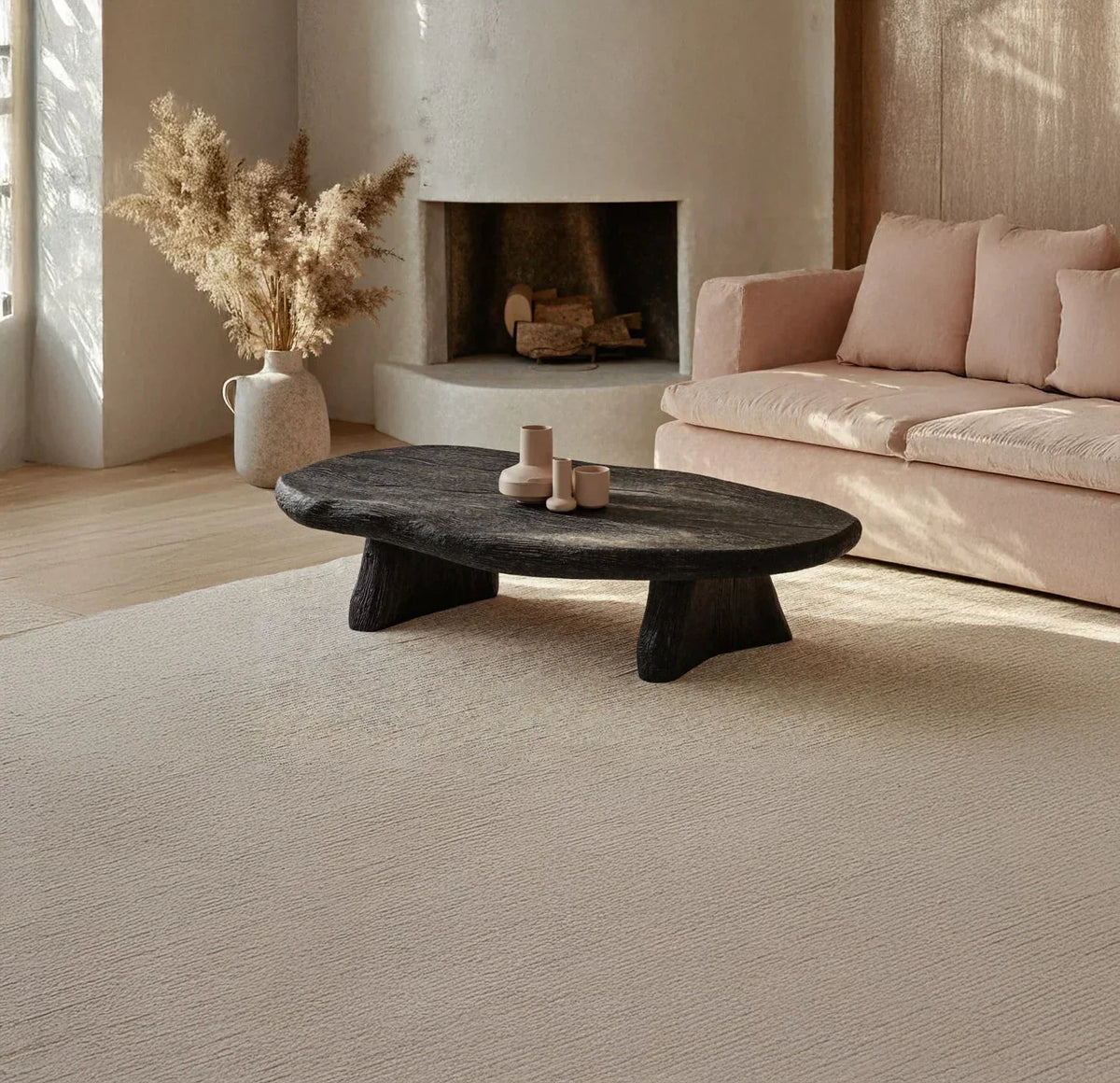 Dark live edge solid wood coffee table in modern living room with beige sofa and fireplace