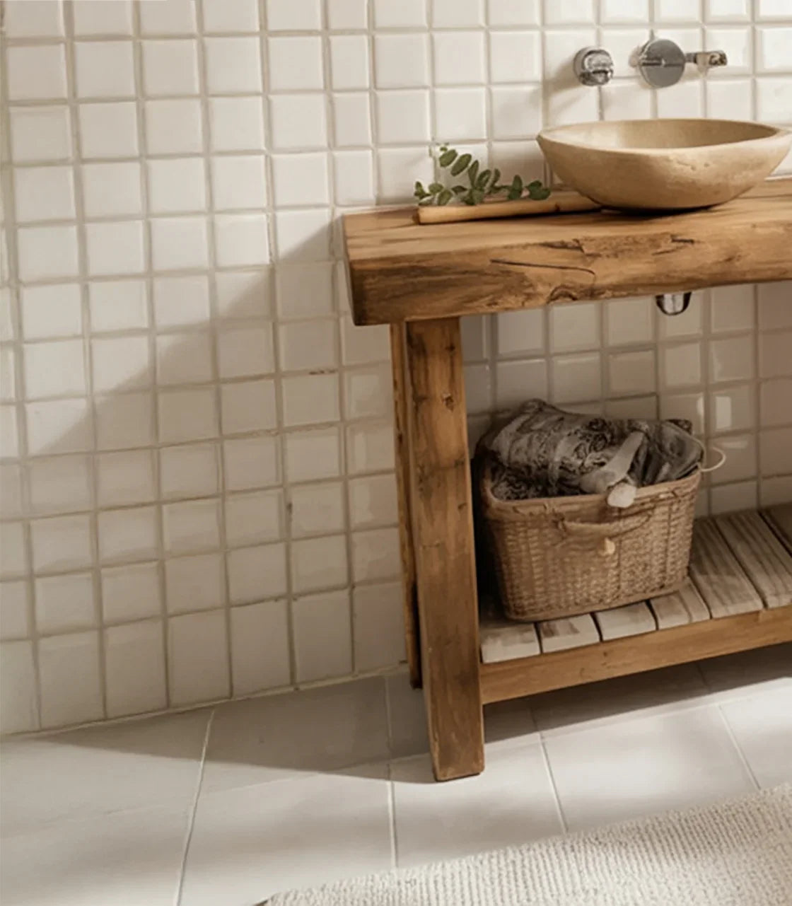 Rustic wooden bathroom vanity with stone vessel sink, woven basket, and white tiled wall