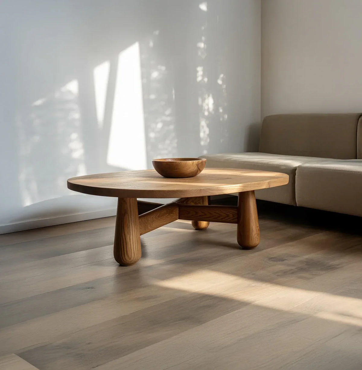 Round solid wood coffee table with bowl, minimalist living room, natural light, modern furniture