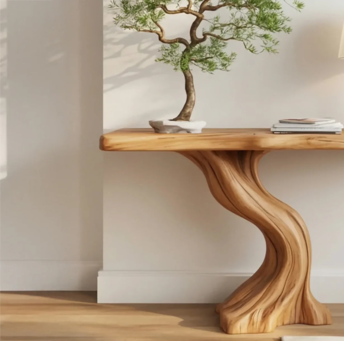 Solid wood live edge console table with sculpted curved base, bonsai tree on top