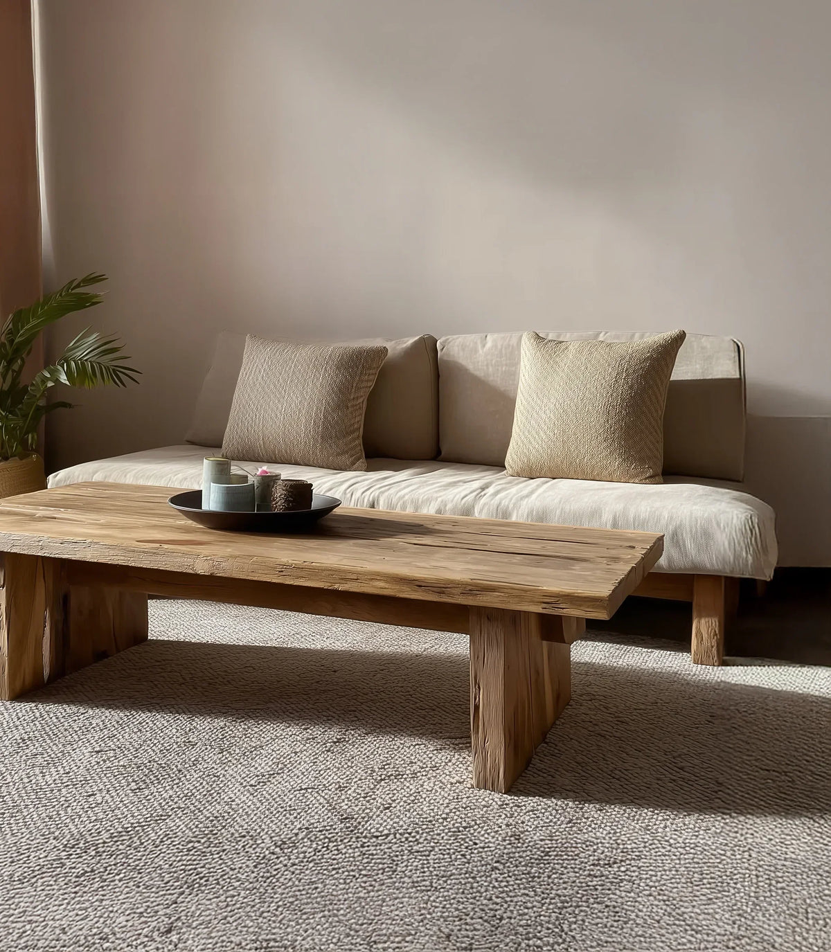 Solid wood live edge coffee table in a modern living room with neutral sofa and sunlight