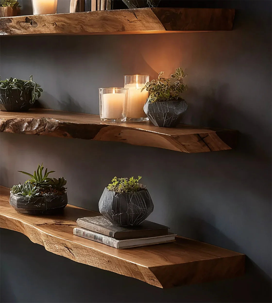 Natural wood floating shelves with candles and potted succulents against dark wall