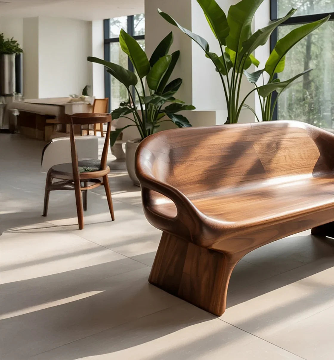 Modern wooden bench and chair in sunlit room with large windows and green potted plants