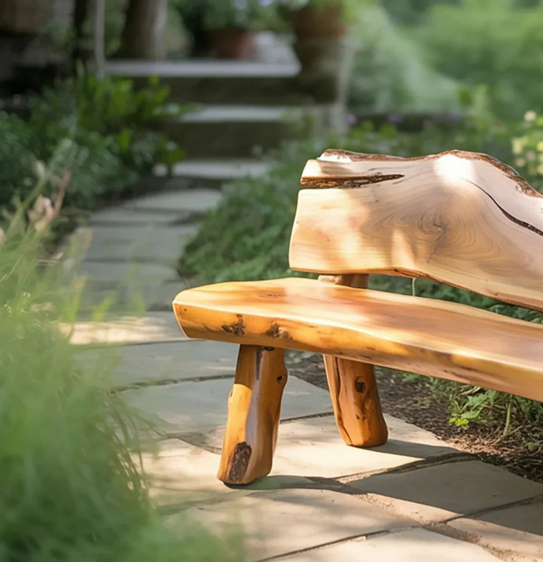 Wooden garden bench on stone pathway surrounded by green plants in a peaceful outdoor setting