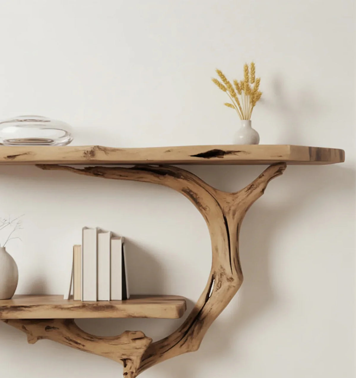 Rustic wooden wall shelf with books, ceramic vases, and dried wheat decor on white wall