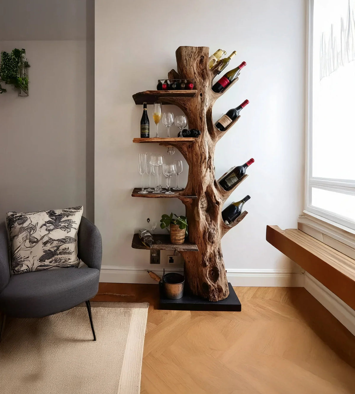 Rustic wooden wine rack shaped like a tree trunk with wine bottles and glasses in a modern living room