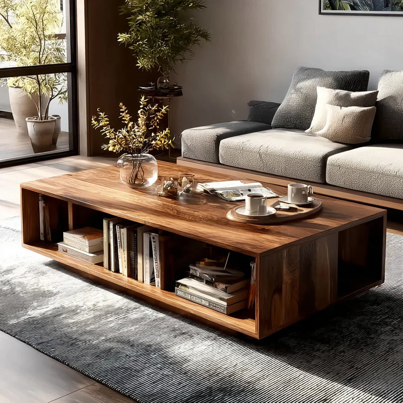 Modern living room featuring a wooden coffee table with books, vase, and cups on a textured rug