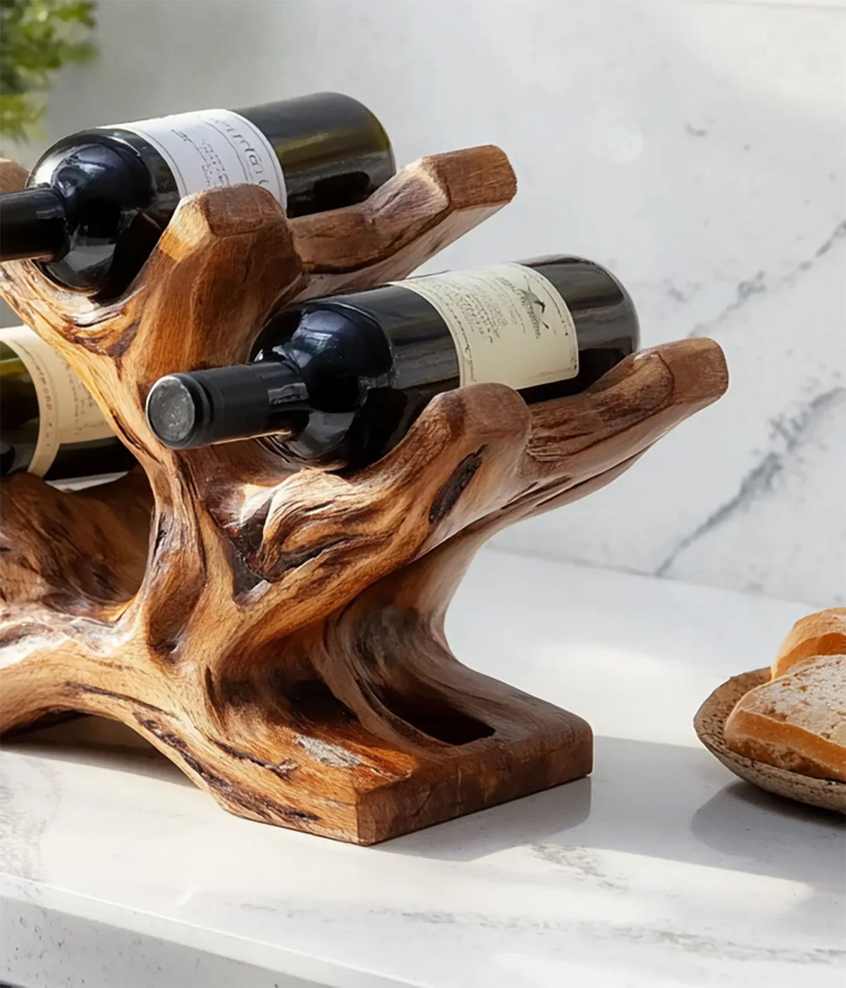 Solid wood live edge wine rack holding bottles on a marble countertop, rustic decor