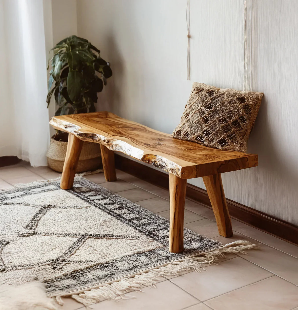 Live edge solid wood bench with natural grain, set on a patterned rug in a cozy room.